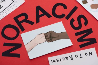 black no racism lettering and picture with drawn multiethnic hands doing fist bump on red background clipart