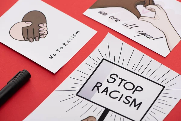 Close up view of marker and pictures with multiethnic hands on red background — Stock Image Close View Marker Pictures Multiethnic Hands Red Background Royalty Free Stock Photos