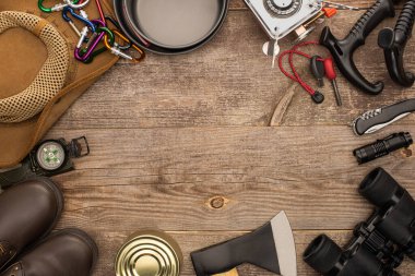 top view of camping equipment on wooden table with copy space clipart