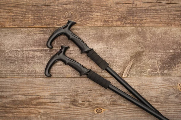 Top View Black Trekking Poles Wooden Surface — Stock Photo, Image