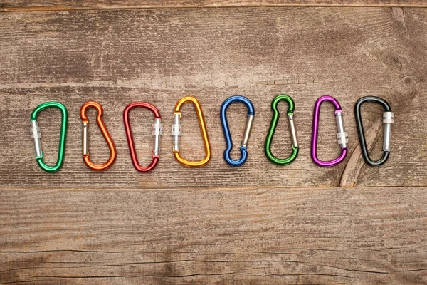Top View Colorful Carabiners Row Wooden Table — Stock Photo, Image