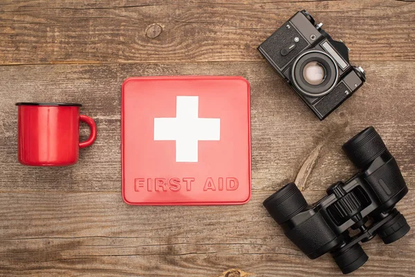 Top View First Aid Kit Photo Camera Binoculars Red Metal — Stock Photo, Image