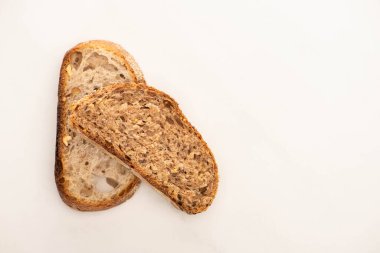 top view of fresh whole grain bread slices on white background clipart