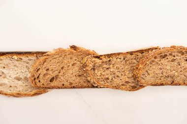 top view of whole grain bread slices in line on white background clipart