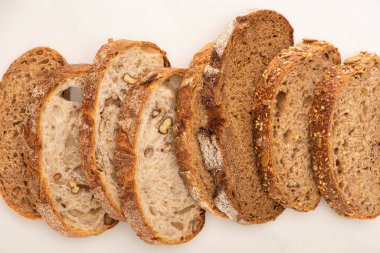 top view of fresh whole wheat bread slices on white background clipart