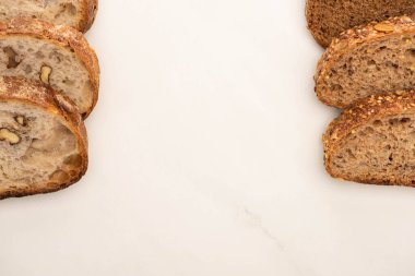top view of fresh whole wheat bread slices on white background with copy space clipart