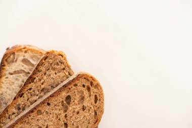 top view of whole wheat bread slices on white background with copy space clipart