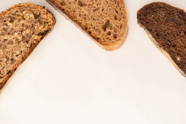 top view of fresh whole wheat bread slices on white background with copy space clipart