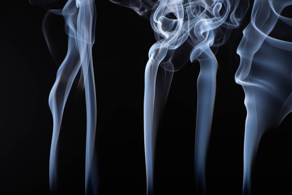 abstract white flowing smoke steams on black background