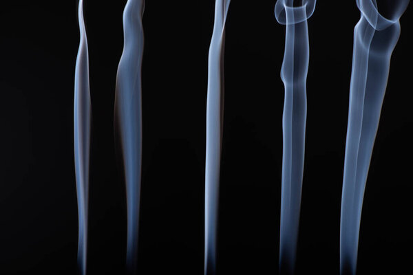 abstract white flowing smoke steams on black background