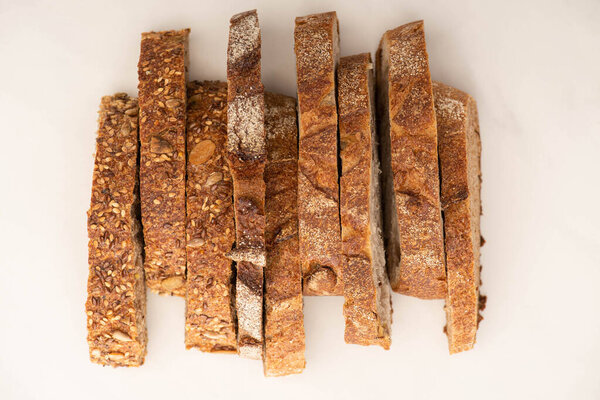 top view of tasty whole wheat bread slices on white background