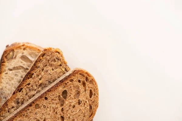 コピースペース付きの白い背景に全粒小麦パンのスライスのトップビュー — ストック写真