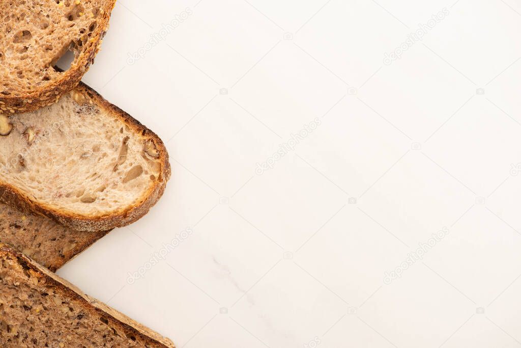 top view of tasty whole grain bread slices on white background with copy space