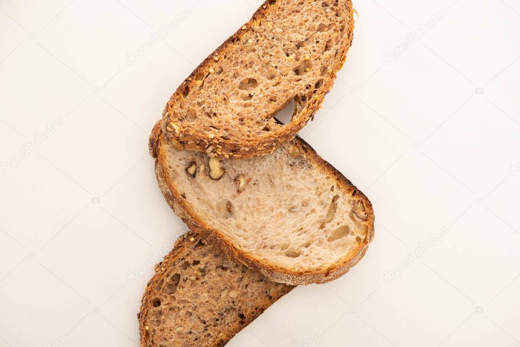 top view of tasty whole grain bread slices on white background