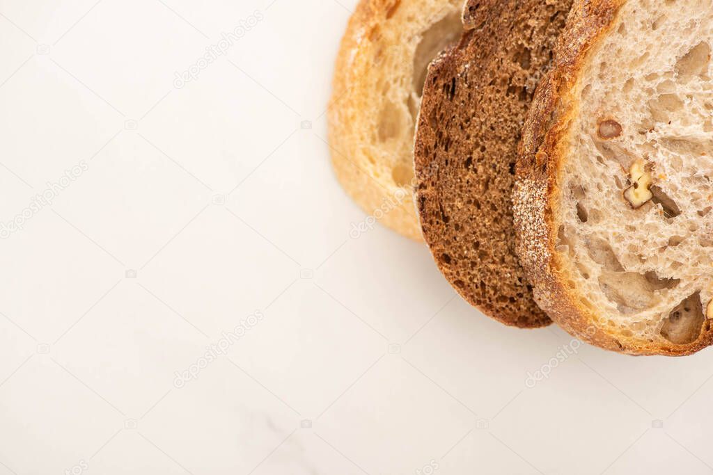 top view of fresh bread slices on white background with copy space