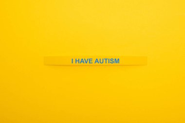 top view of bracelet with I have autism inscription isolated on yellow clipart