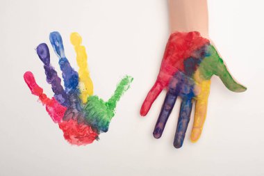 cropped view of female hand with colorful handprint on white for World Autism Awareness Day clipart