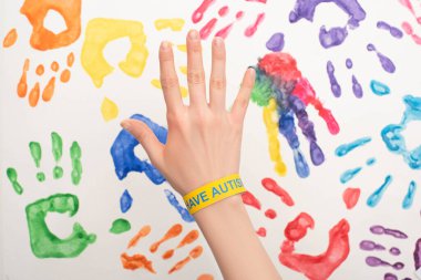 cropped view of female hand with autism bracelet on white with hand prints clipart