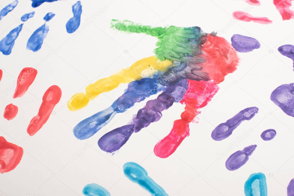 top view of colorful hand prints on white for World Autism Awareness Day 