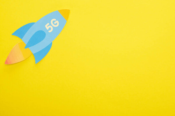 top view of paper rocket with 5g lettering on yellow background