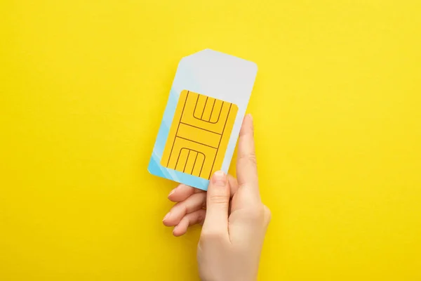 Cropped View Woman Holding Sim Card Yellow Background — Stock Photo, Image