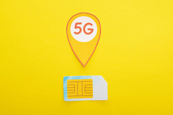 top view of sim card and 5g lettering on yellow background