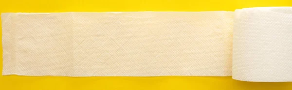 Top View Unrolled White Toilet Paper Yellow Background Panoramic Shot — Stock Photo, Image