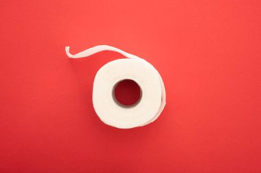 top view of white toilet paper roll on red background clipart