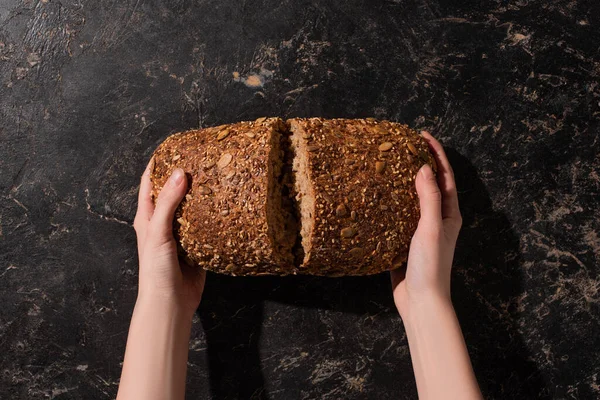 Cropped View Woman Holding Cut Whole Grain Bread Stone Black — Stock Photo, Image