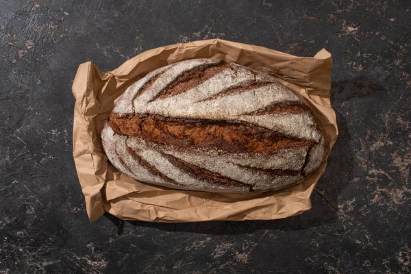 Top View Organic Brown Bread Loaf Paper Stone Black Surface — Stock Photo, Image