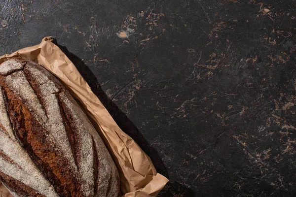 Top View Organic Brown Bread Loaf Paper Stone Black Surface — Stock Photo, Image