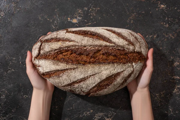 Cropped View Woman Holding Brown Bread Stone Black Surface — Stock Photo, Image