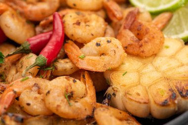 close up view of fried shrimps with grilled corn and chili peppers clipart