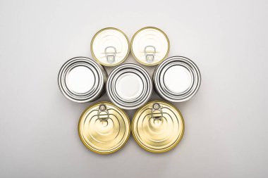 top view of cans with canned food on white background, food donation concept clipart