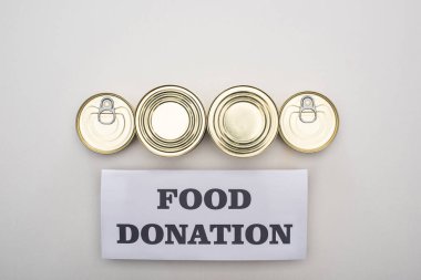 flat lay with cans on white background with food donation card clipart