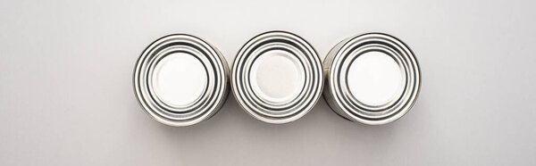 flat lay with silver cans on white background, food donation concept