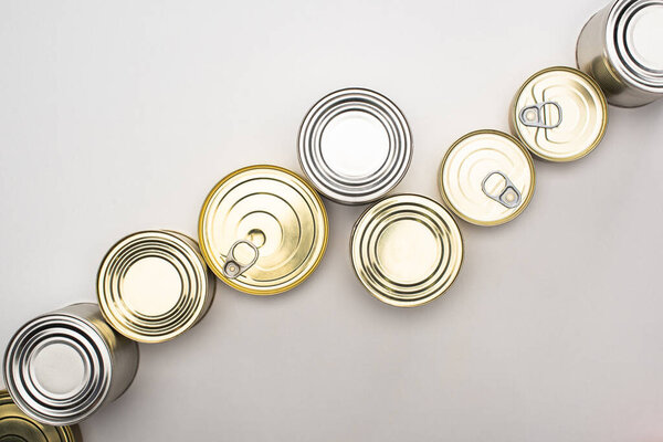 top view of cans with canned food on white background, food donation concept