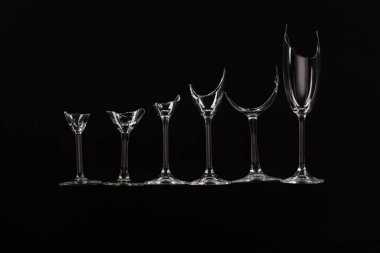 broken sharp transparent glasses in row isolated on black clipart