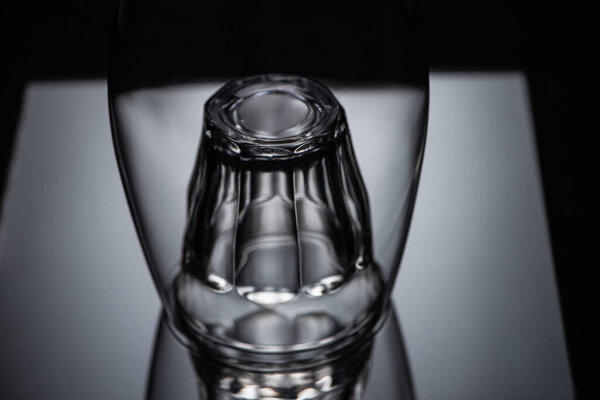 close up view of shot glass in wine glass in dark