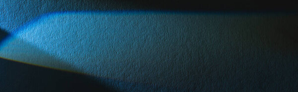 light prism with beam on blue texture background, panoramic crop