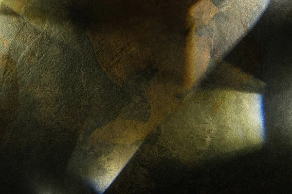 light prism with beams on dark stone texture background