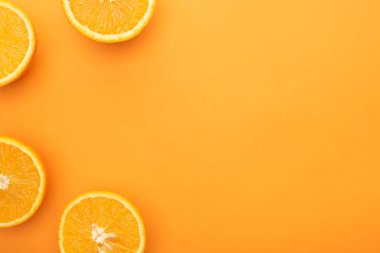 top view of ripe juicy orange slices on colorful background with copy space clipart