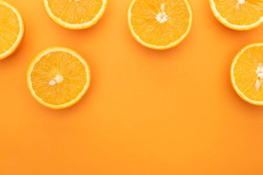top view of ripe juicy orange slices on colorful background with copy space clipart
