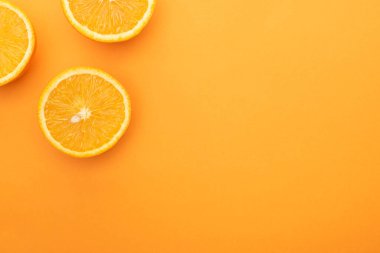 top view of ripe juicy orange slices on colorful background with copy space clipart