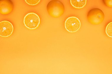 top view of ripe juicy whole oranges and slices on colorful background clipart