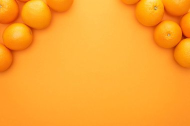 top view of ripe juicy whole oranges on colorful background with copy space clipart