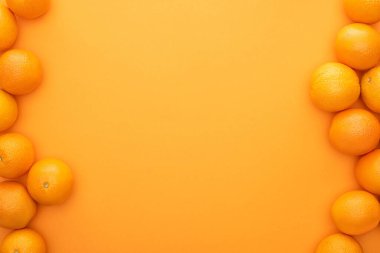 top view of ripe juicy whole oranges on colorful background clipart