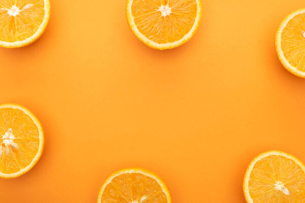 top view of juicy orange slices on colorful background