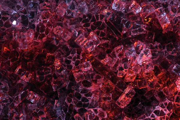 top view of abstract dark red and purple glass textured background
