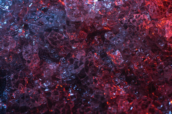 top view of dark abstract red and purple glass textured background